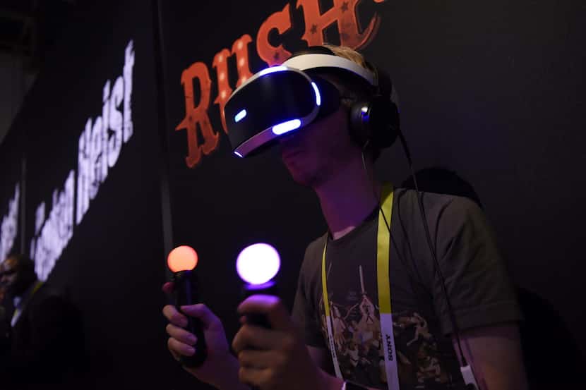  An attendee demonstrates the Sony Corp. PlayStation virtual reality (VR) gaming headset...