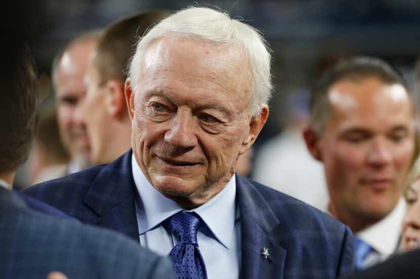 Dallas Cowboys owner Jerry Jones walks the sidelines before the first half of an NFL game...