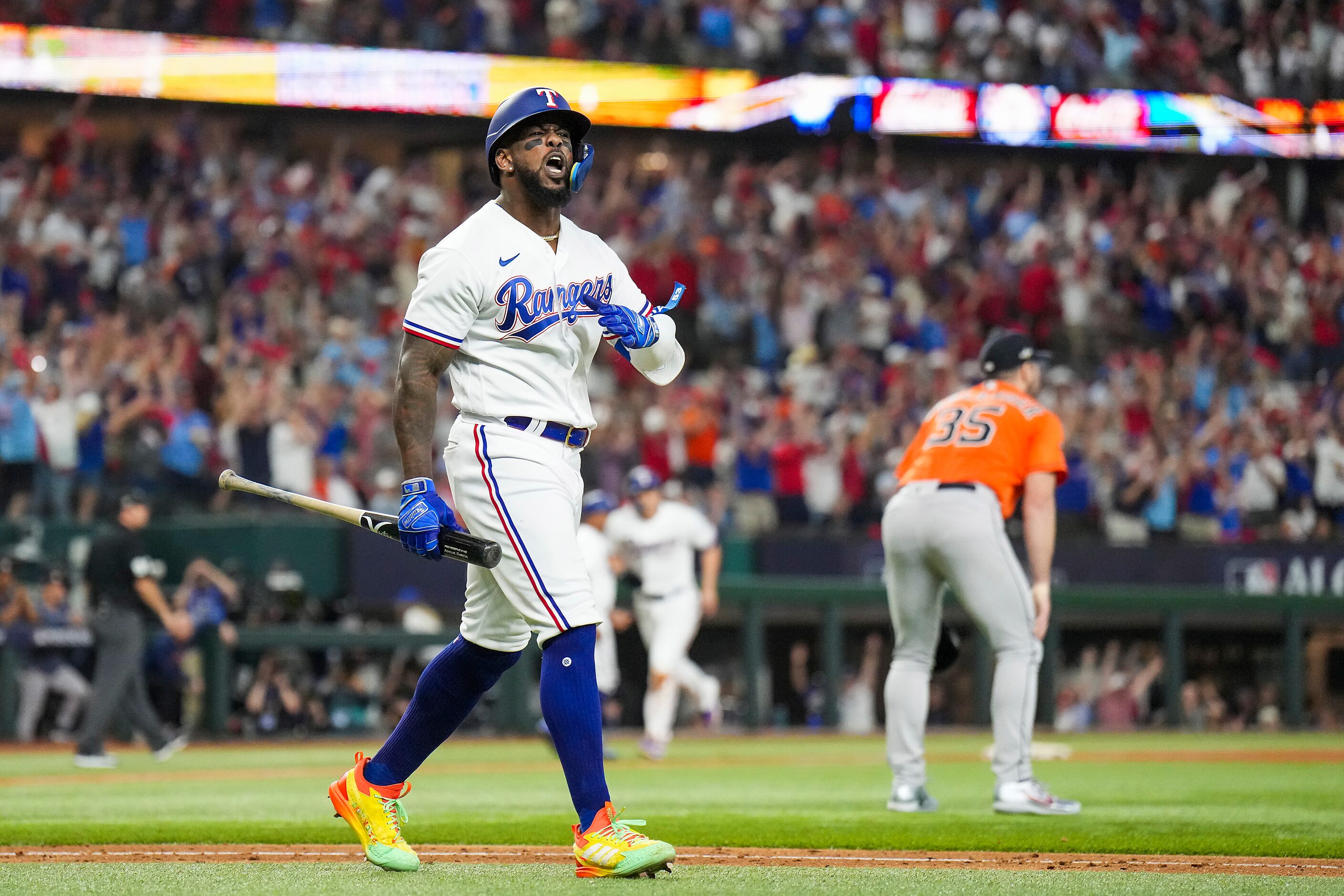 Texas Rangers right fielder Adolis Garcia celebrates after hitting a three-run home run off...