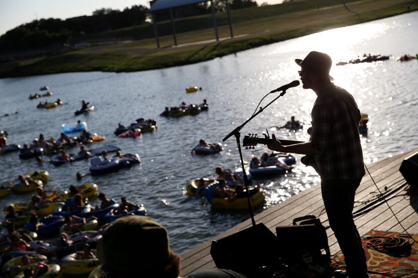 Ace Crayton, of the Thieving Birds, plays for ears on the beach and in the Trinity River in...
