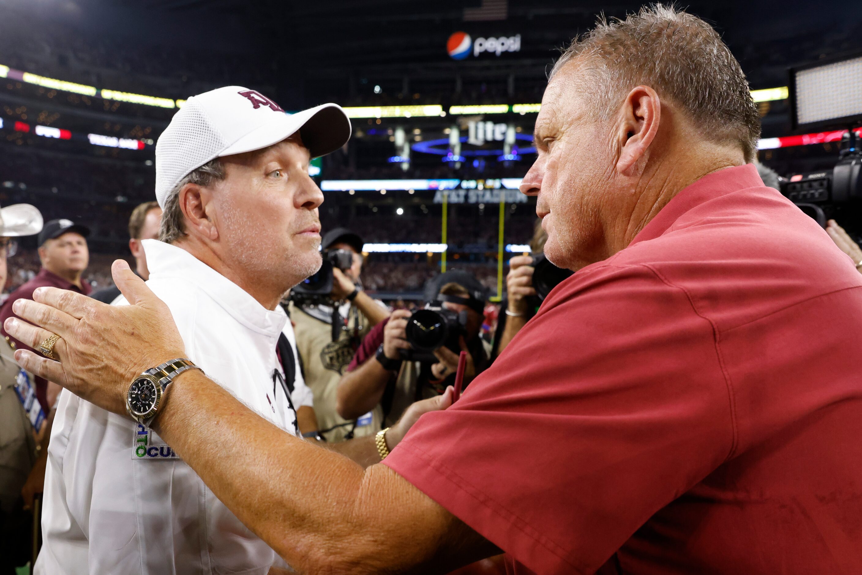 Arkansas head coach Sam Pittman, right, and Texas A&M head coach Jimbo Fisher greets each...