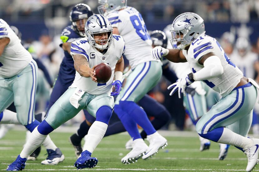 Dallas Cowboys quarterback Dak Prescott (4) hands the ball off to Dallas Cowboys running...