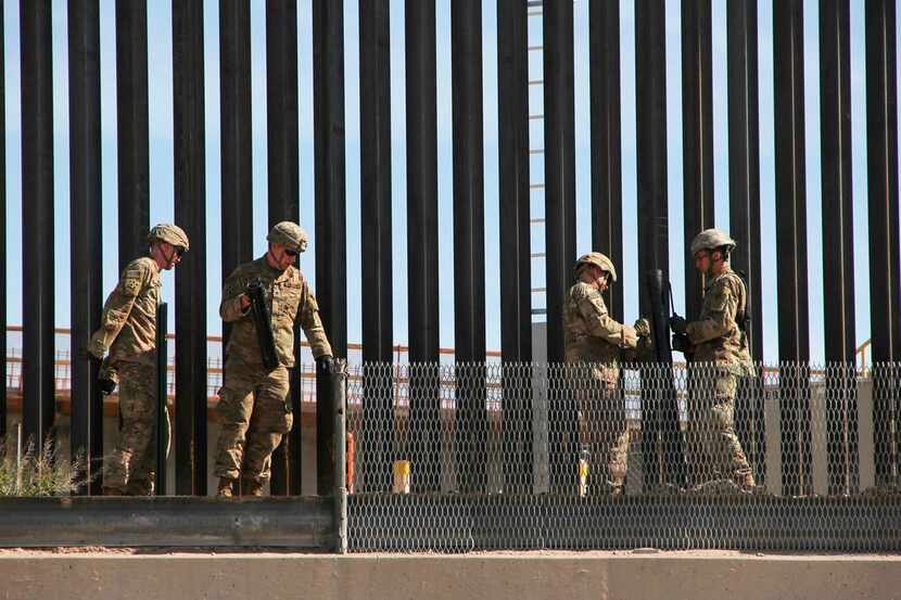 U.S. soldiers reinforce the US-Mexico border fence in El Paso, Texas state, US, as seen from...