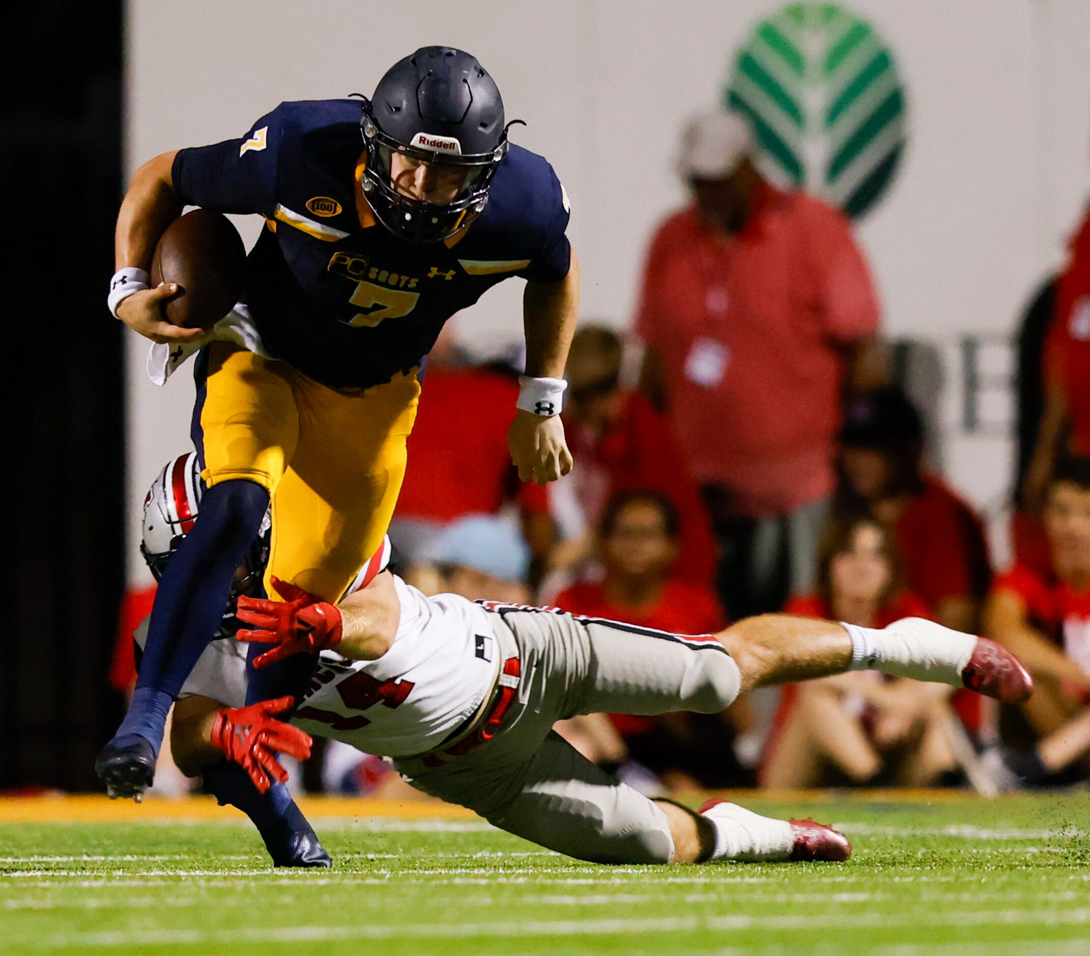 Highland Park quarterback Brennan Storer (7) evades Flower Mound Marcus’ linebacker Colton...