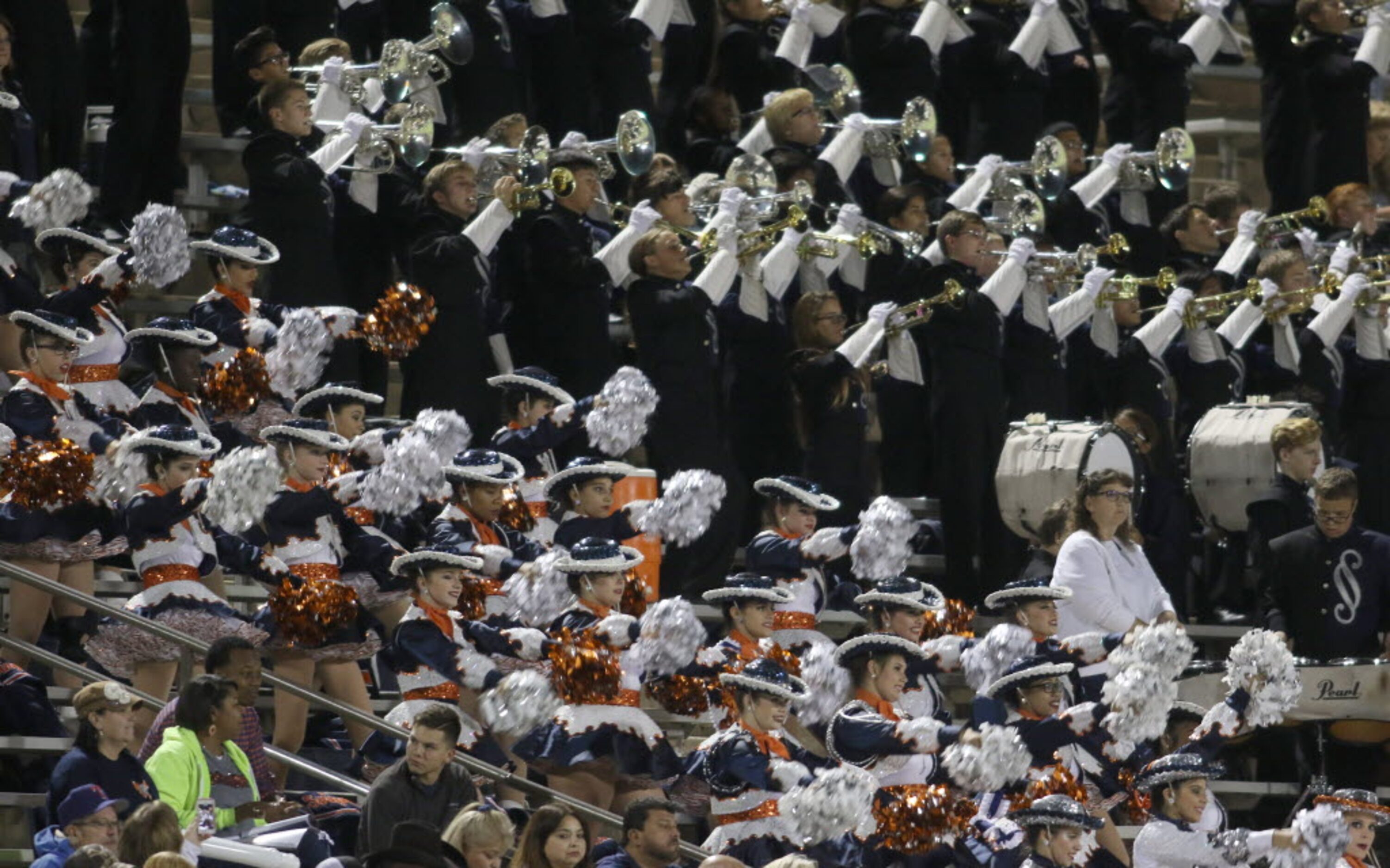 Members of the Sachse band and drill team perform from the stands during first half action...