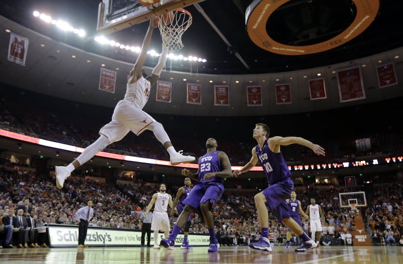 Texas center Prince Ibeh (44) drives to the basket over TCU defenders Devonta Abron (23) and...