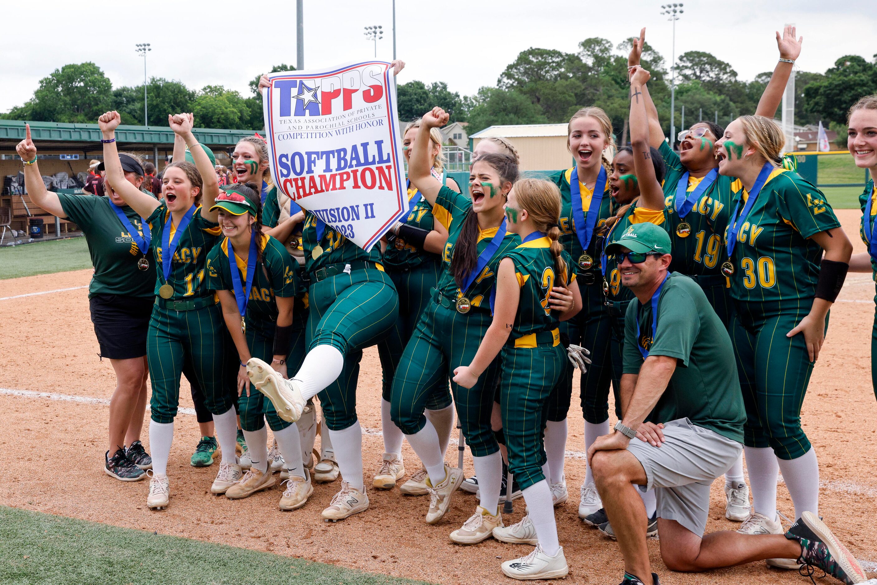 The Frisco Legacy Christian team raises the TAPPS Division II softball state championship...