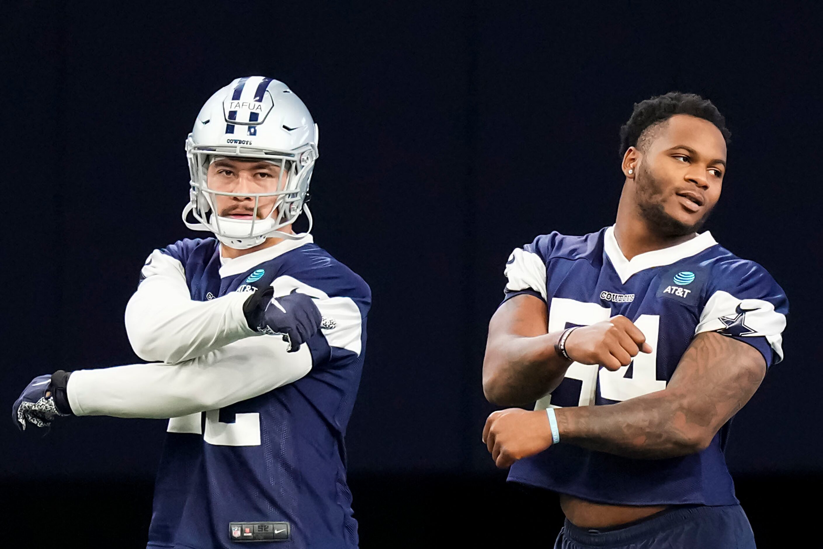 Dallas Cowboys defensive end Mike Tafua (52) and defensive end Sam Williams (54) stretch...