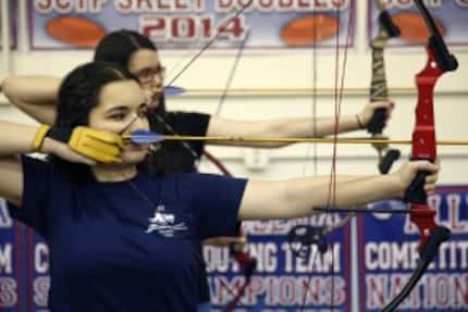  Dorothy Cobb, 16, aims her arrow during archery practice at Allen ISD's Lowery Freshman...