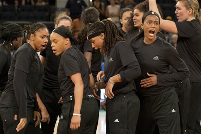 Members of the New York Liberty basketball team shout after a team huddle prior to a game...