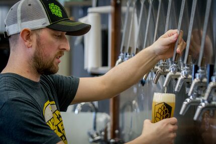 James Peery draws a hazy beer at Turning Point brewery in Bedford.