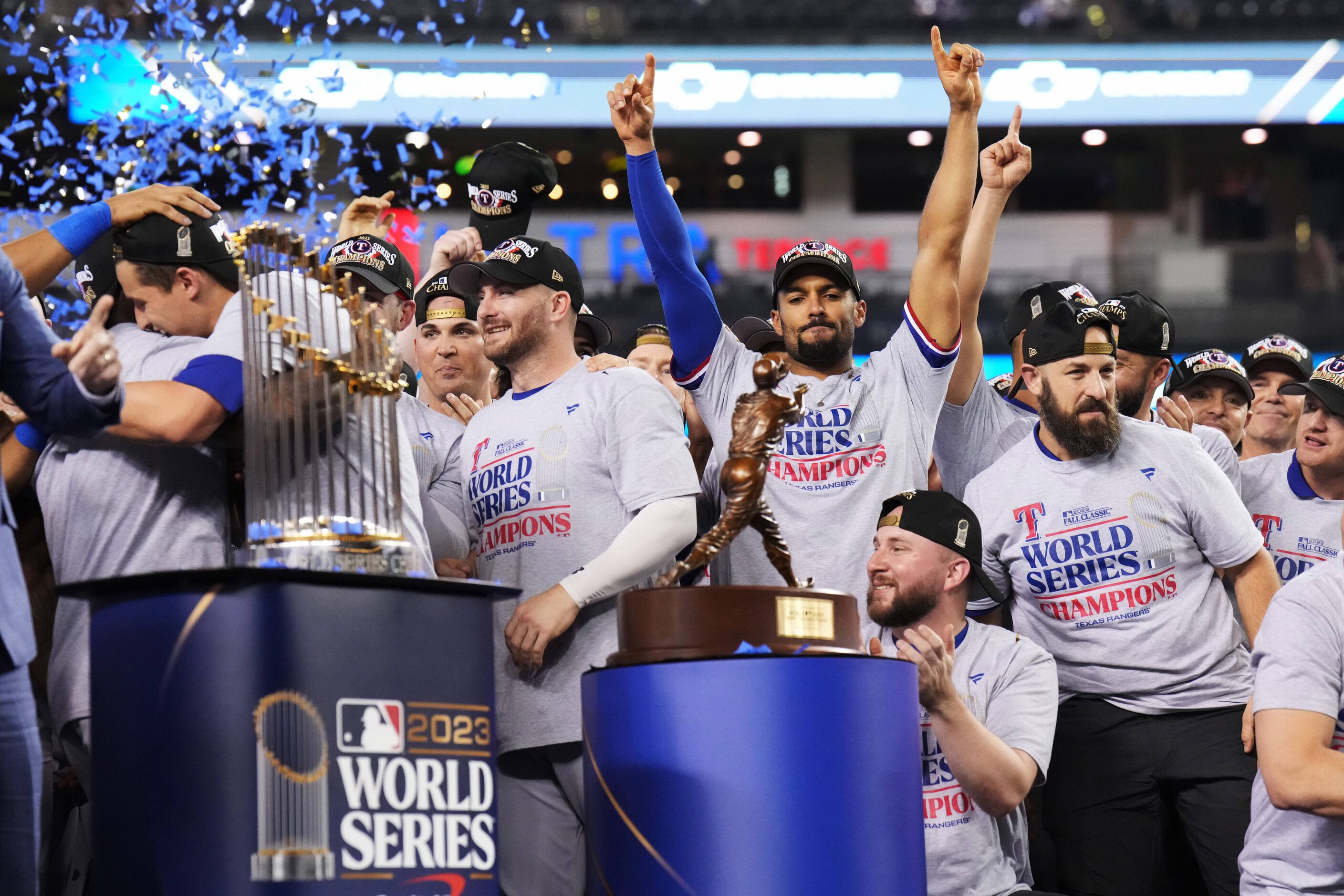 Texas Rangers’ Marcus Semien, center, celebrates winning the World Series after defeating...