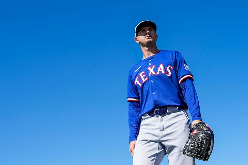 Texas Rangers pitcher Tyler Mahle waliks between drills during the first Spring Training...