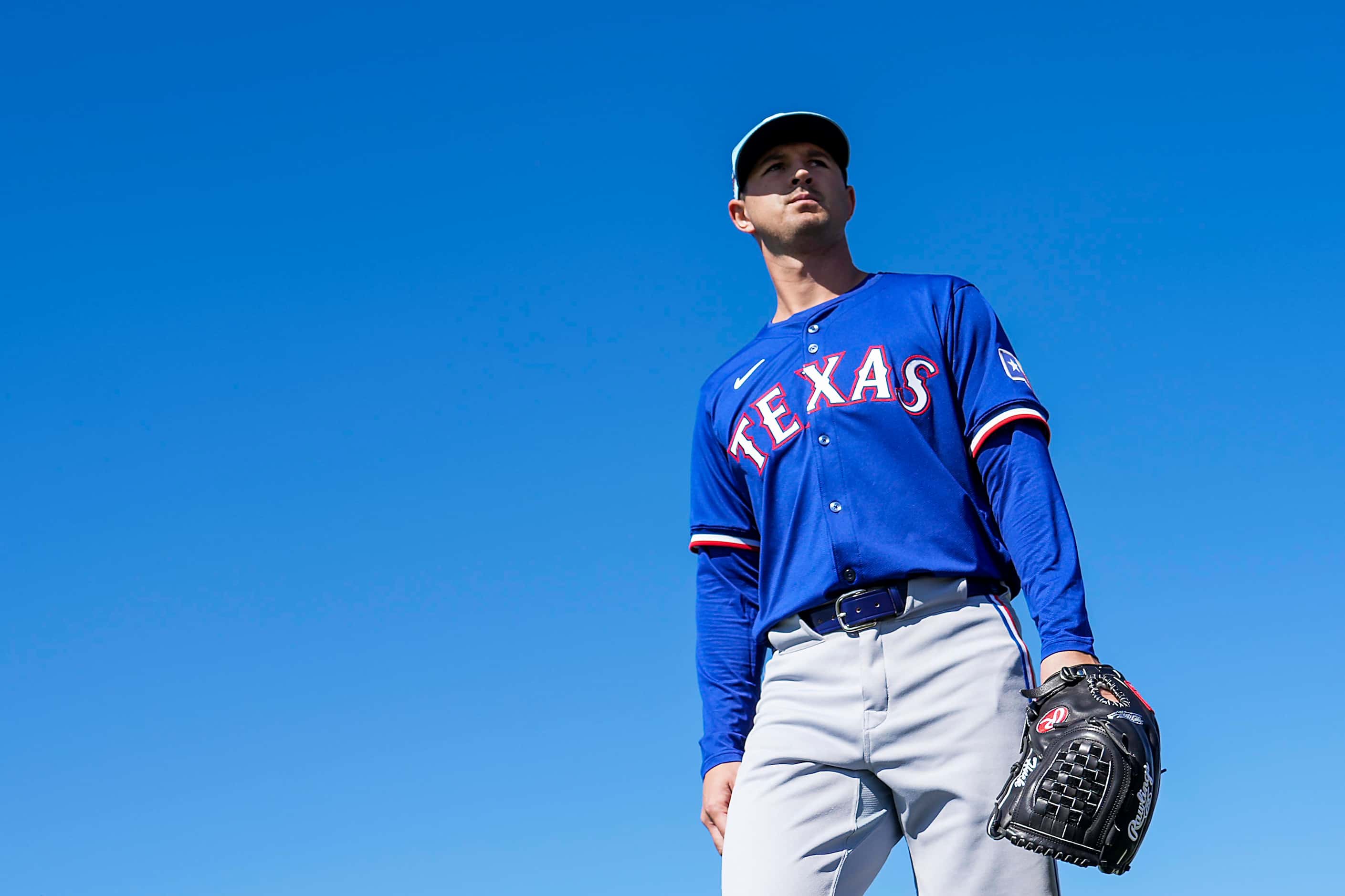 Texas Rangers pitcher Tyler Mahle waliks between drills during the first Spring Training...