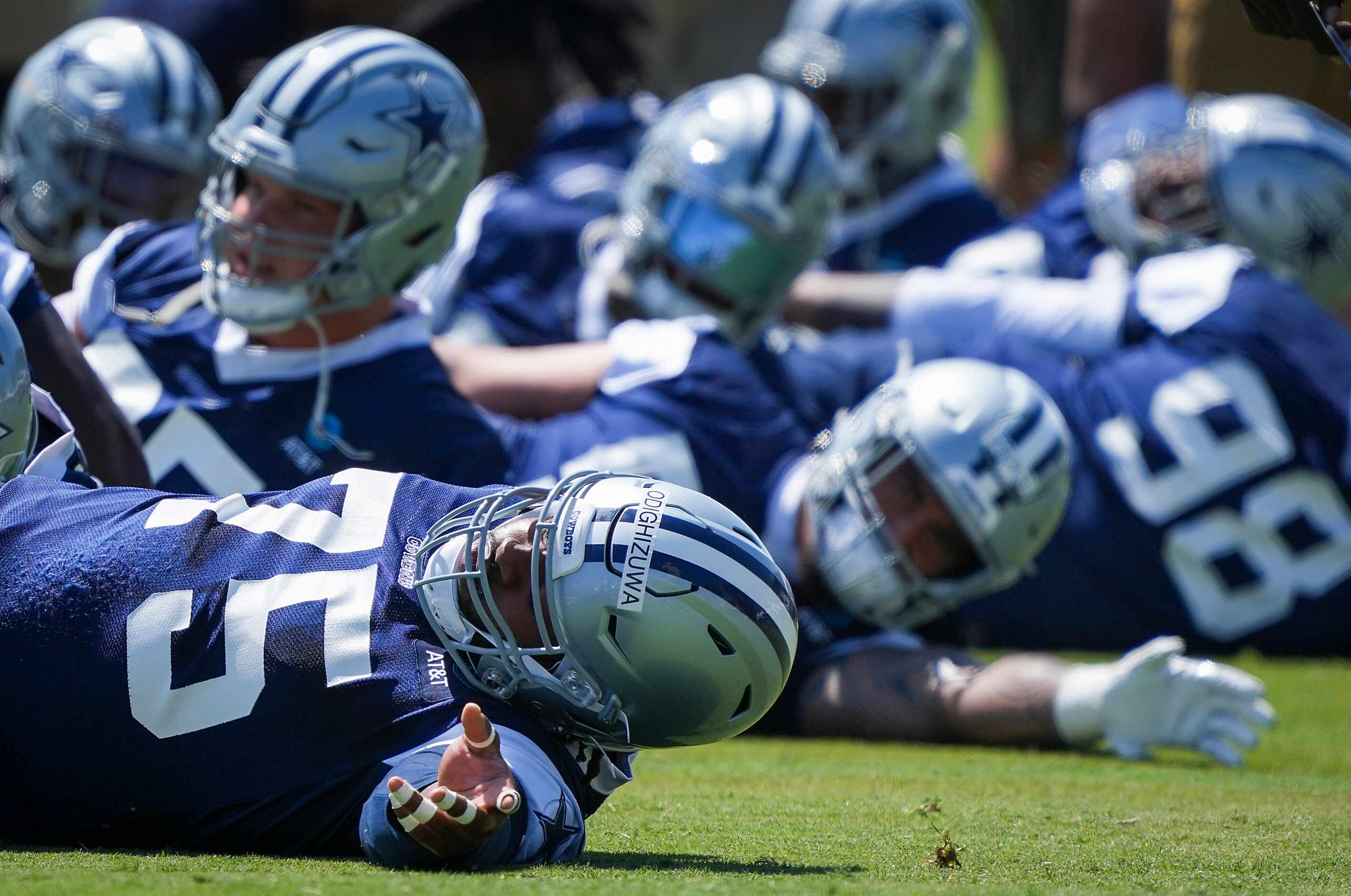 Dallas Cowboys defensive tackle Osa Odighizuwa (75) stretches with teammates during the...