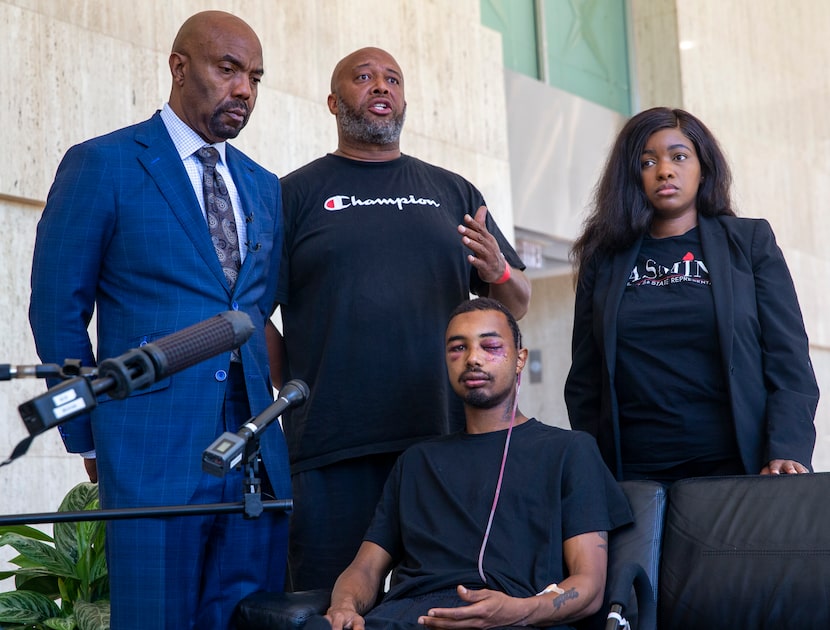 Andre Ray (center standing) speaks about the severe injuries sustained by his son, Brandon...