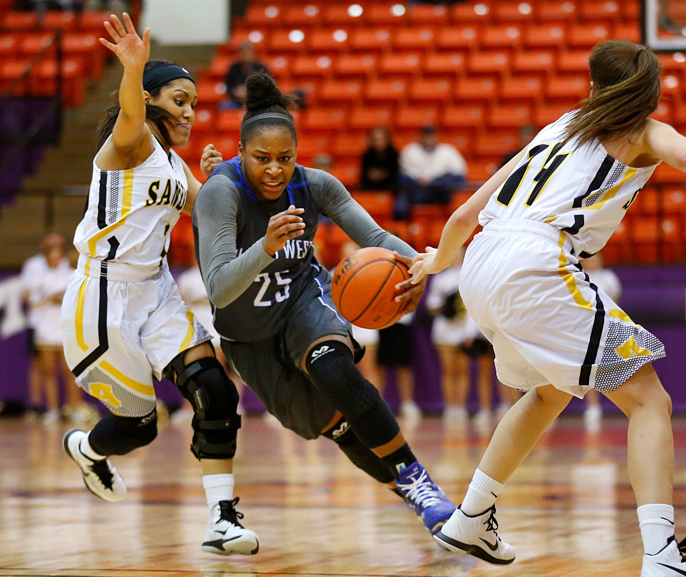 Plano West guard Sydney Skinner (25) splits Amarillo defenders wing Ashlyn Hoover (14) and...