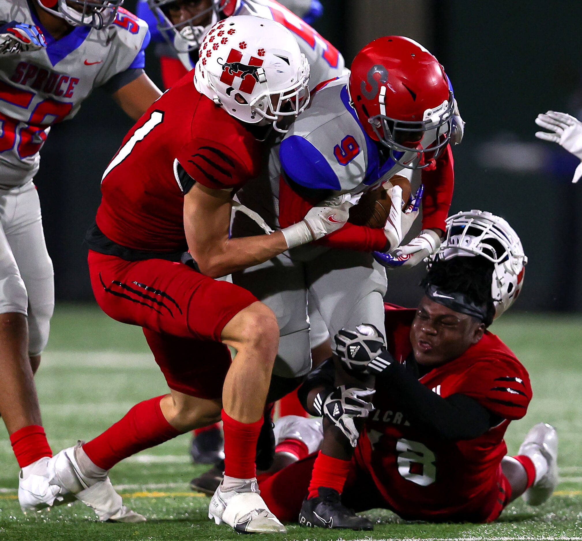 Spruce running back Vinyaun Cohen (9) get stuffed on a run against Hillcrest linebacker Ford...