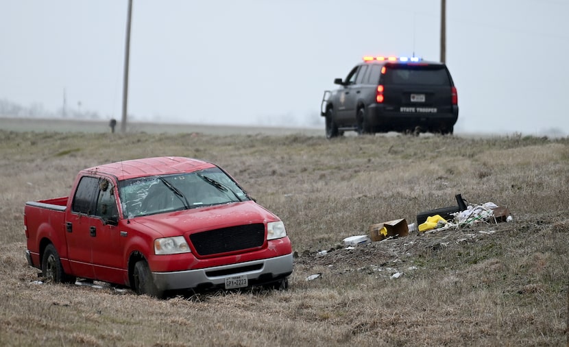 A Texas DPS unit sits near where a truck went off US 380 due to ice, Wednesday, Feb. 23,...