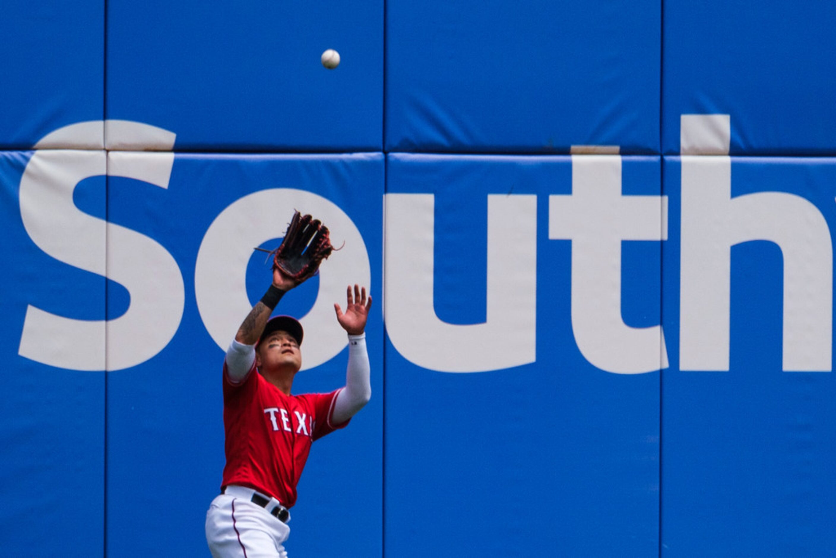 Texas Rangers right fielder Shin-Soo Choo makes a catch on a fly ball off the bat of Seattle...