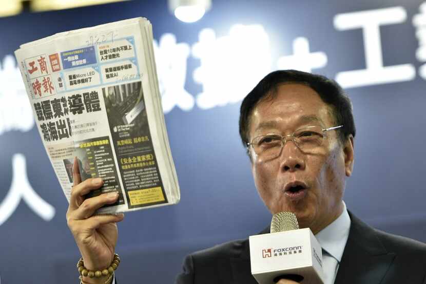 Terry Gou, Chairman of Taiwan's Foxconn, also known as Hon Hai, displays a Chinese version...