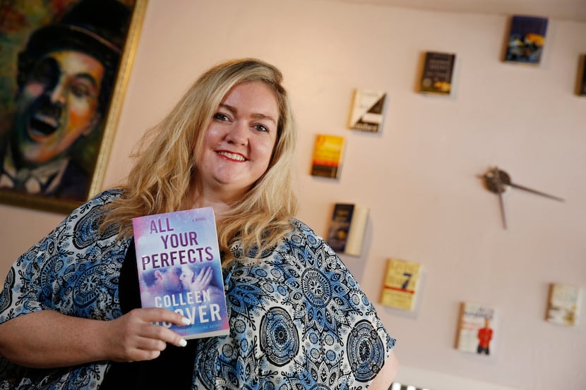 Author Colleen Hoover holds her book All Your Perfects at her bookstore, The Bookworm Box,...