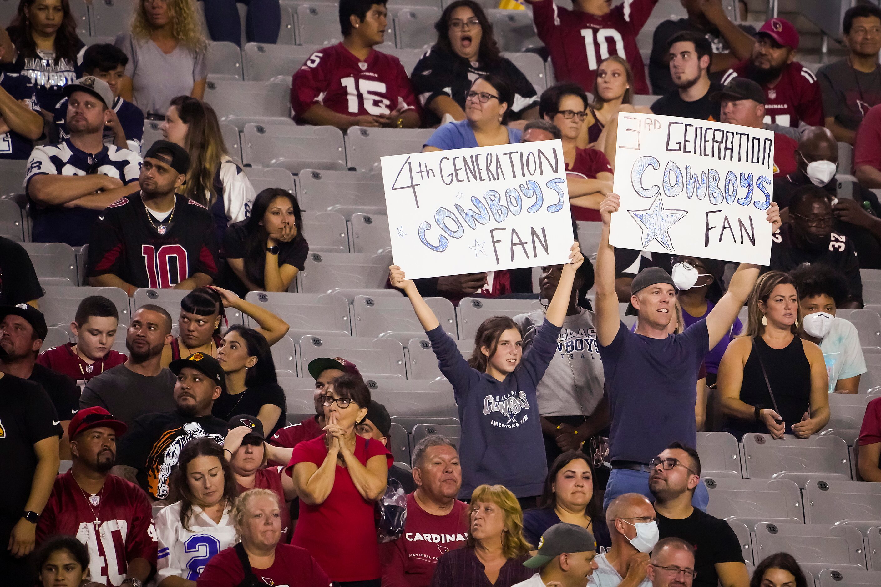 Dallas Cowboys fans cheer their team during the second half of a preseason NFL football game...