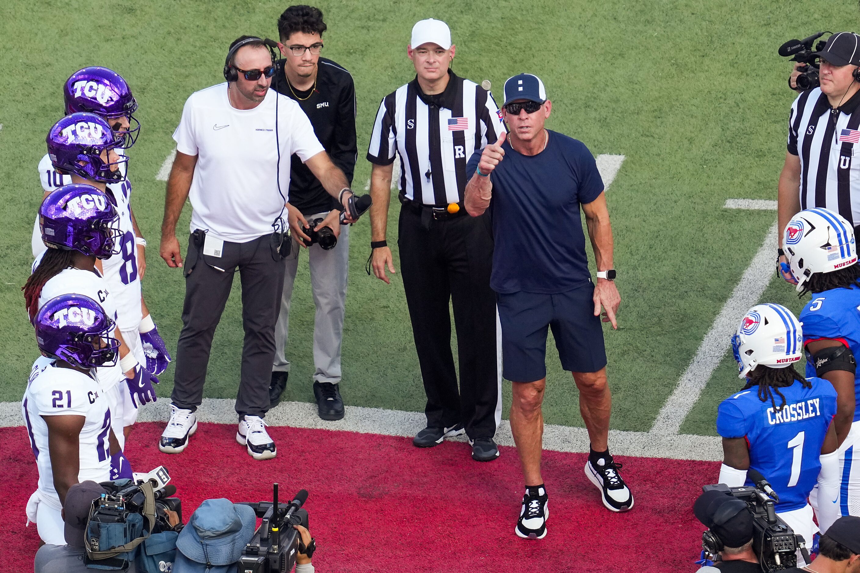 Troy Aikman performs the coin toss before an NCAA football game between SMU and TCU at Ford...