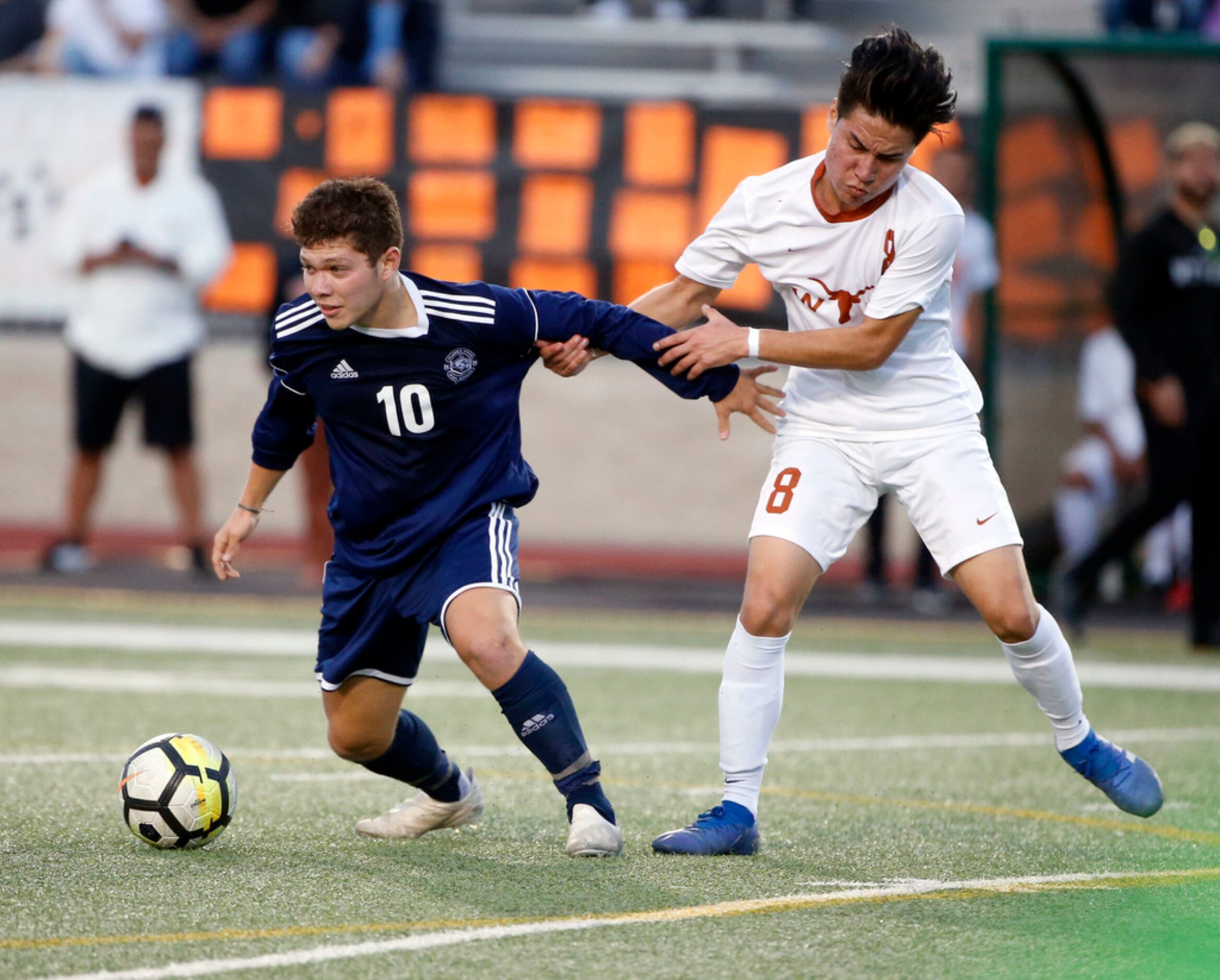 Flower Mound player Hector Torres (10) is grabbed by W.T. White's Kelman Guevara (8) during...