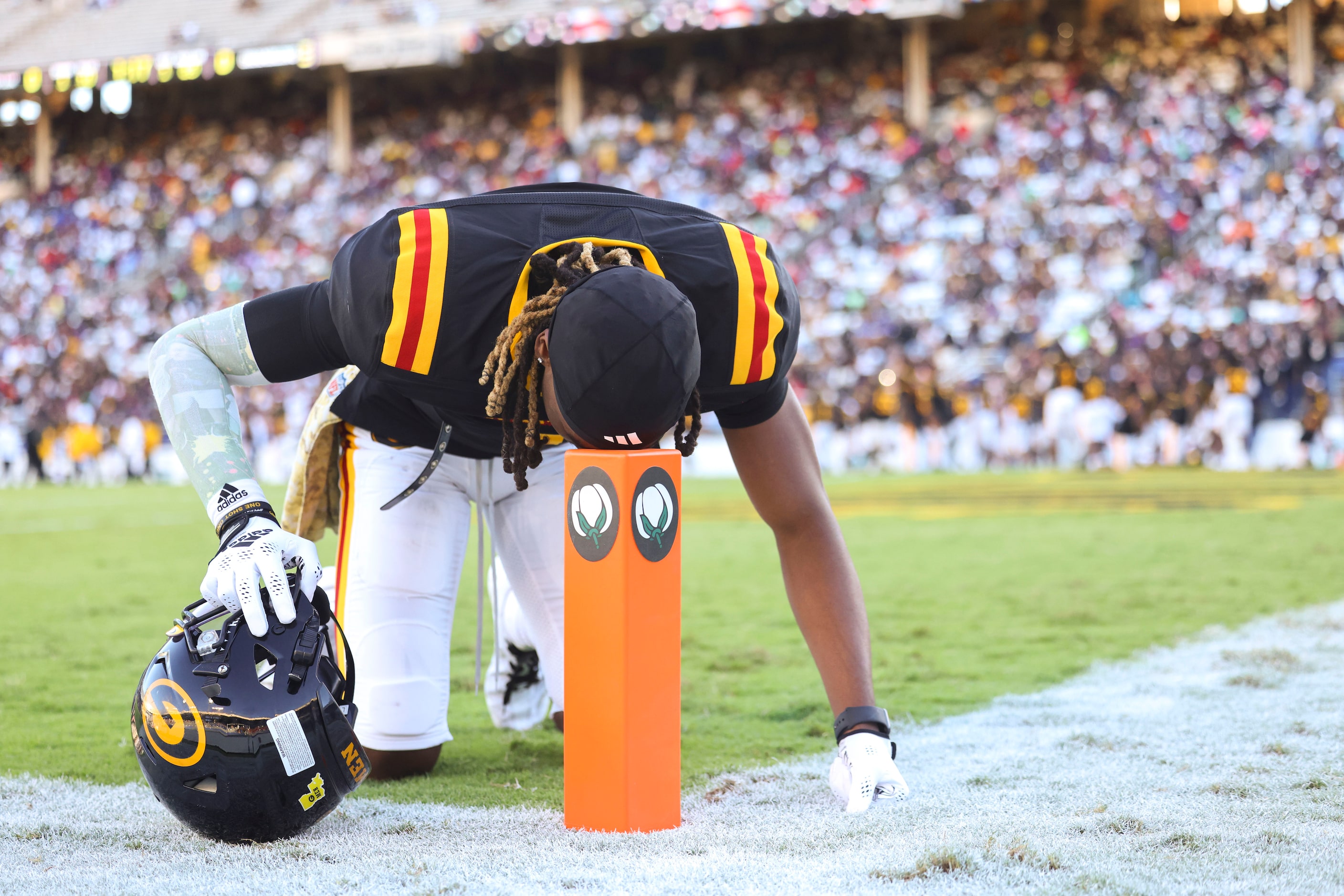 Grambling State wide receiver JR Waters rests his head on the pylon at the end zone as he...