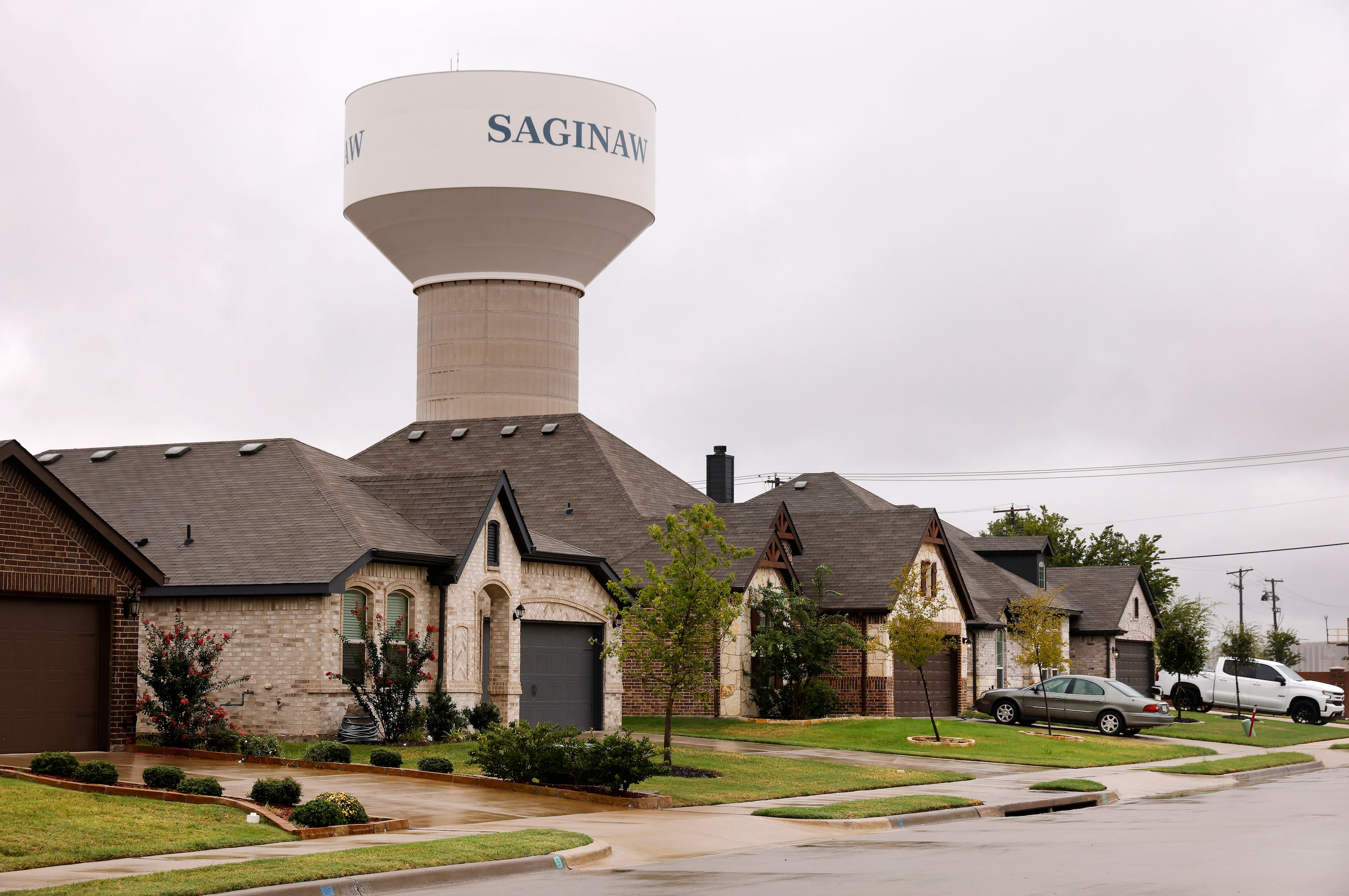 A water tower rises above a new neighborhood in Saginaw.