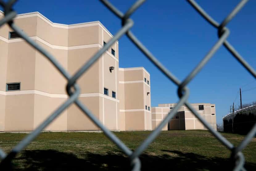 
A barbed wire fence lines the perimeter of the Henry Wade Juvenile Justice Center in Dallas...
