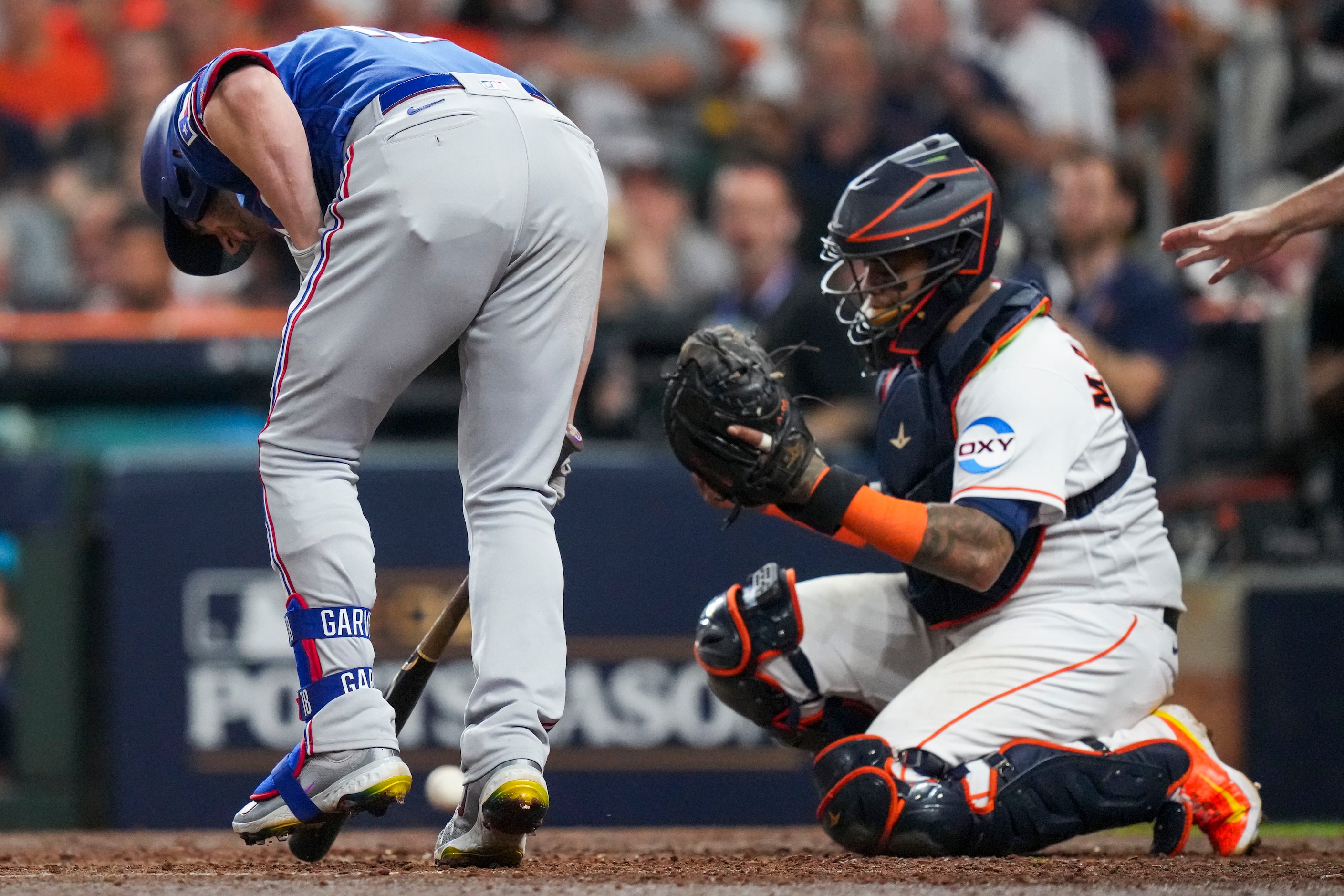 Texas Rangers designated hitter Mitch Garver (18) is hit by a pitch from Houston Astros...