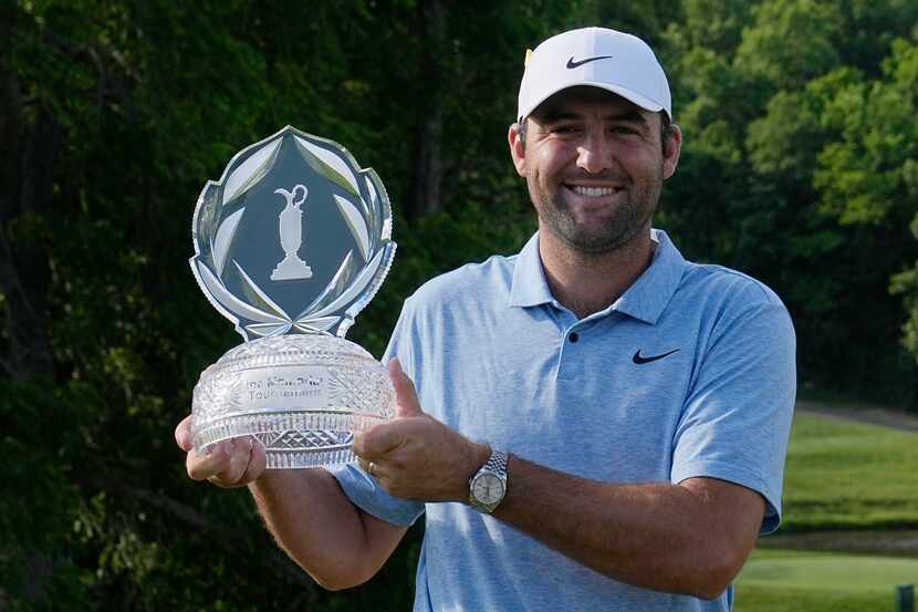Scottie Scheffler poses for a photo with the trophy after winning the Memorial golf...