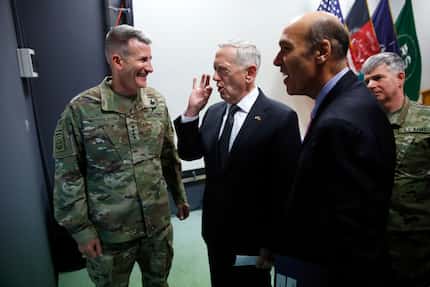 U.S. Defense Secretary James Mattis (center) chats with U.S. Army Gen. John Nicholson...
