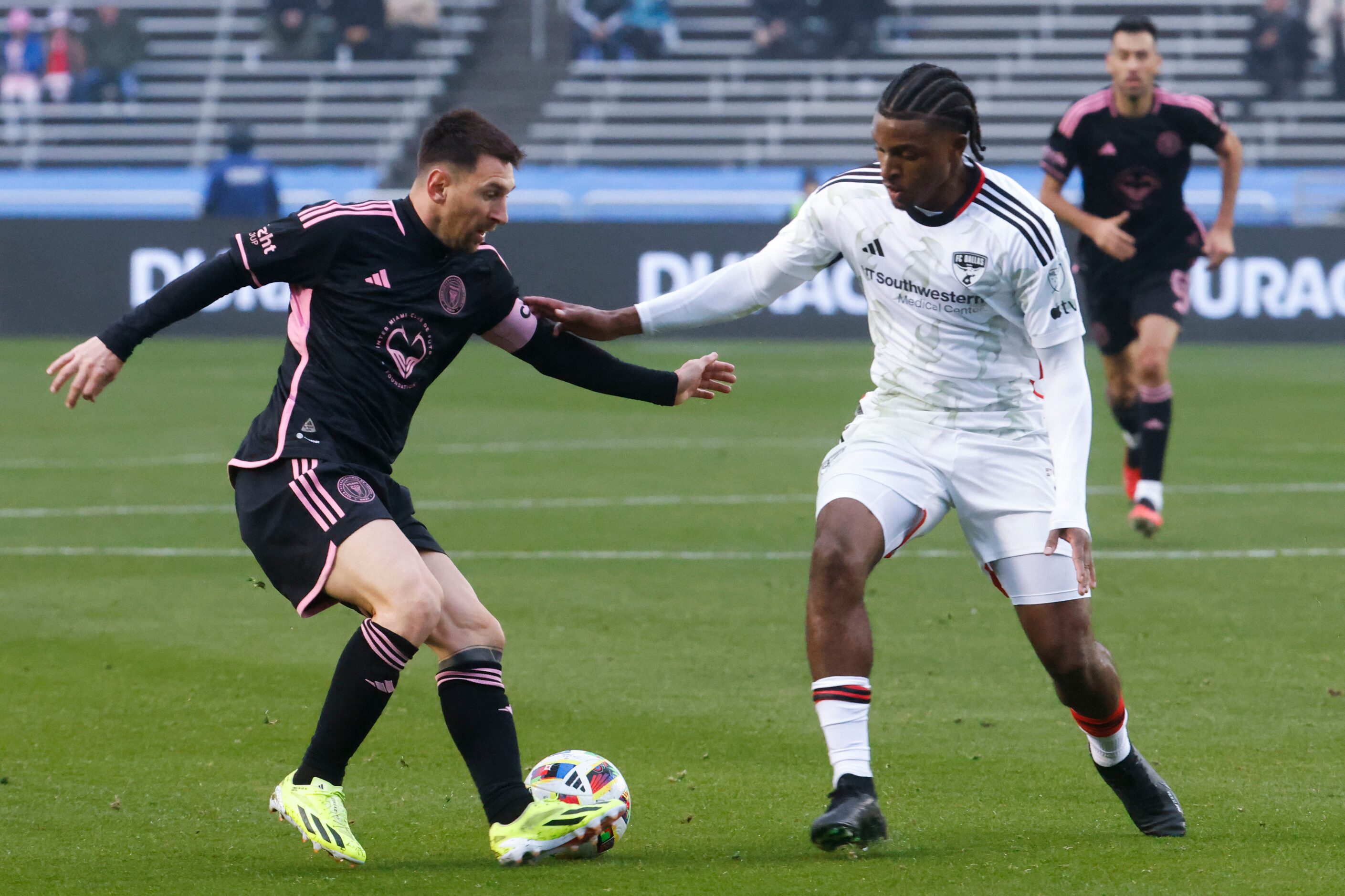 Inter Miami forward Lionel Messi (left) dribbles the ball away from FC Dallas forward Dante...