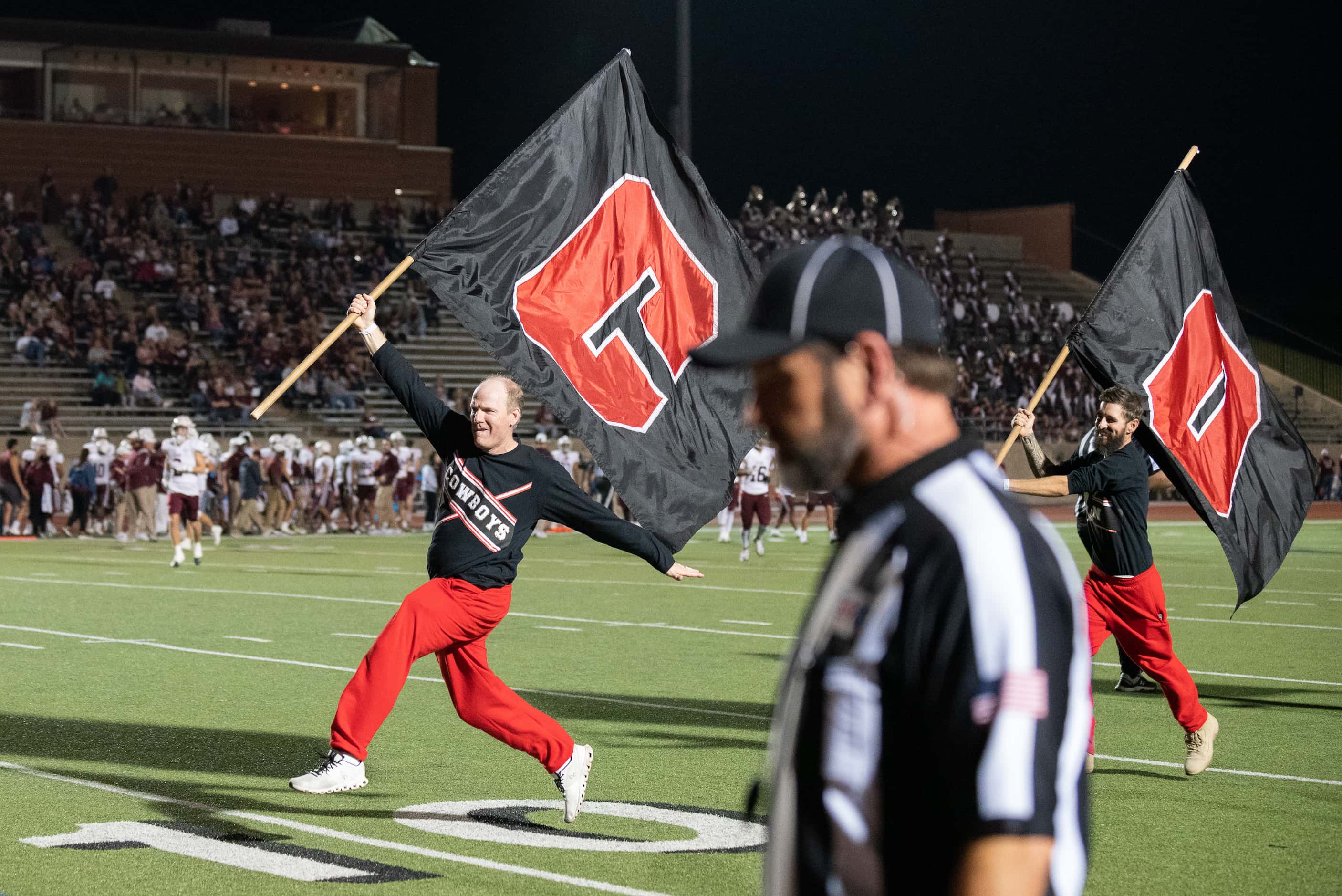 Coppell Cheer Team Dad Blaine Rozas, left, leads a pack of dads as they celebrated a Coppell...