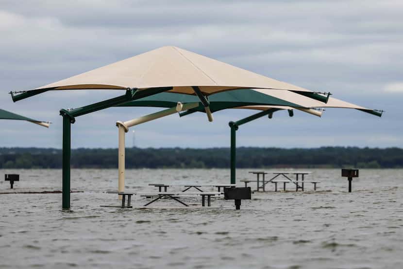 The water level at Grapevine Lake keeps covered the grill stalls for park visitors in...