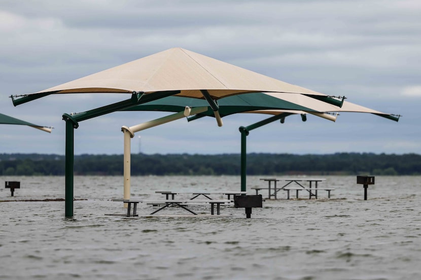 The water level at Grapevine Lake keeps covered the grill stalls for park visitors in...