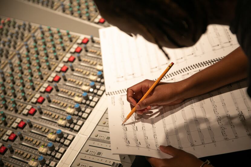 Damoyee Janai Neroes working on the composition that will provide the new music that...