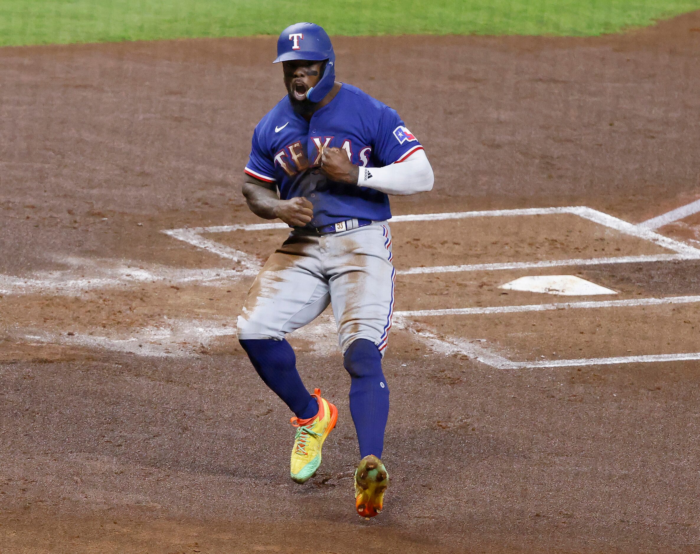 Texas Rangers Adolis Garcia (53) crosses home plate for a score off of a Mitch Garver since...