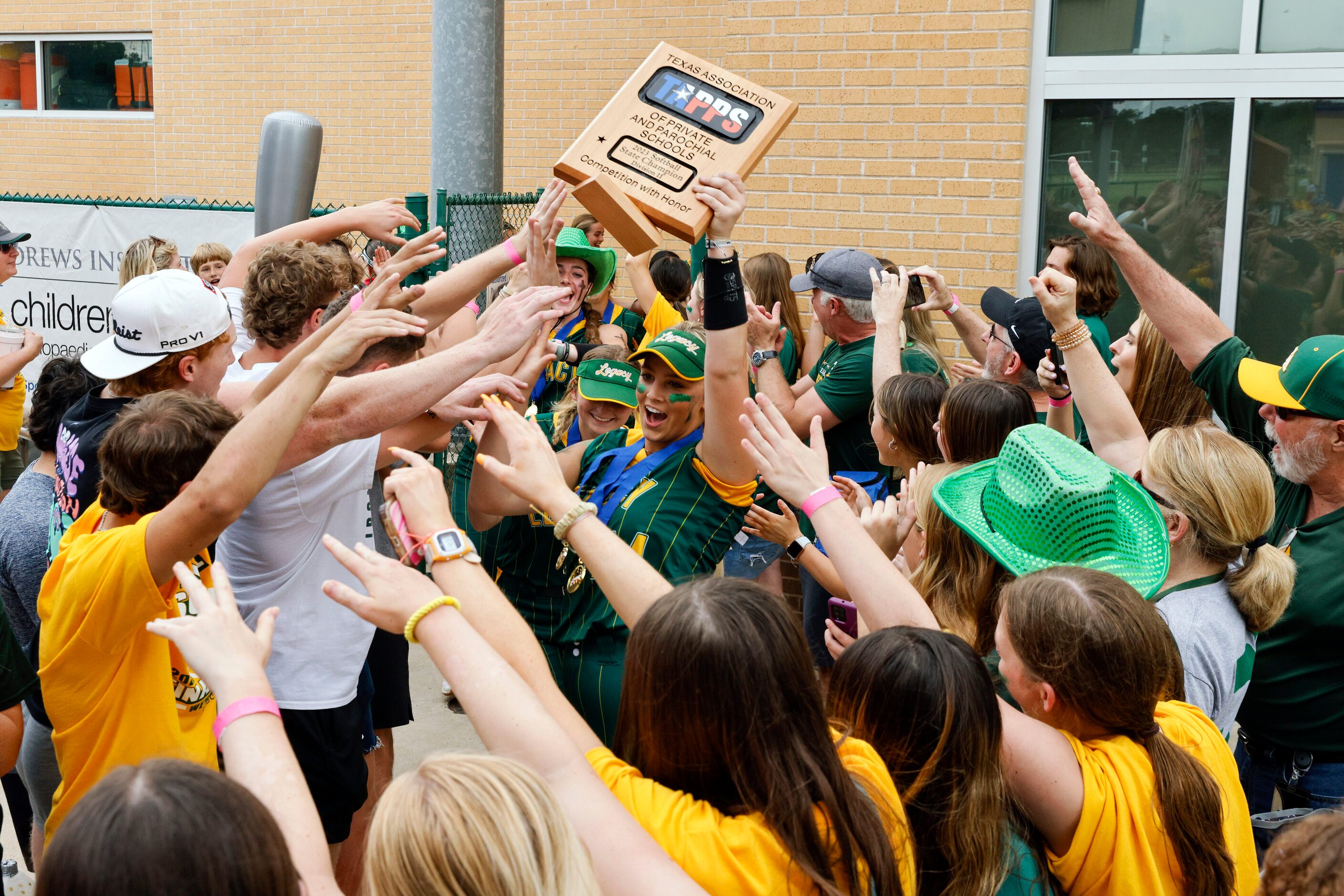 Frisco Legacy Christian pitcher Ronnie Johnson (44) raises the TAPPS Division II softball...