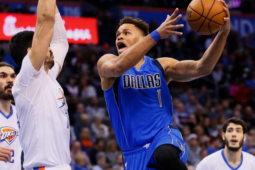 Dallas Mavericks guard Justin Anderson (1) goes up for a shot while defended by Oklahoma...