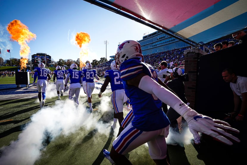 SMU player take the field to face Tulane in an NCAA football game at Ford Stadium on...
