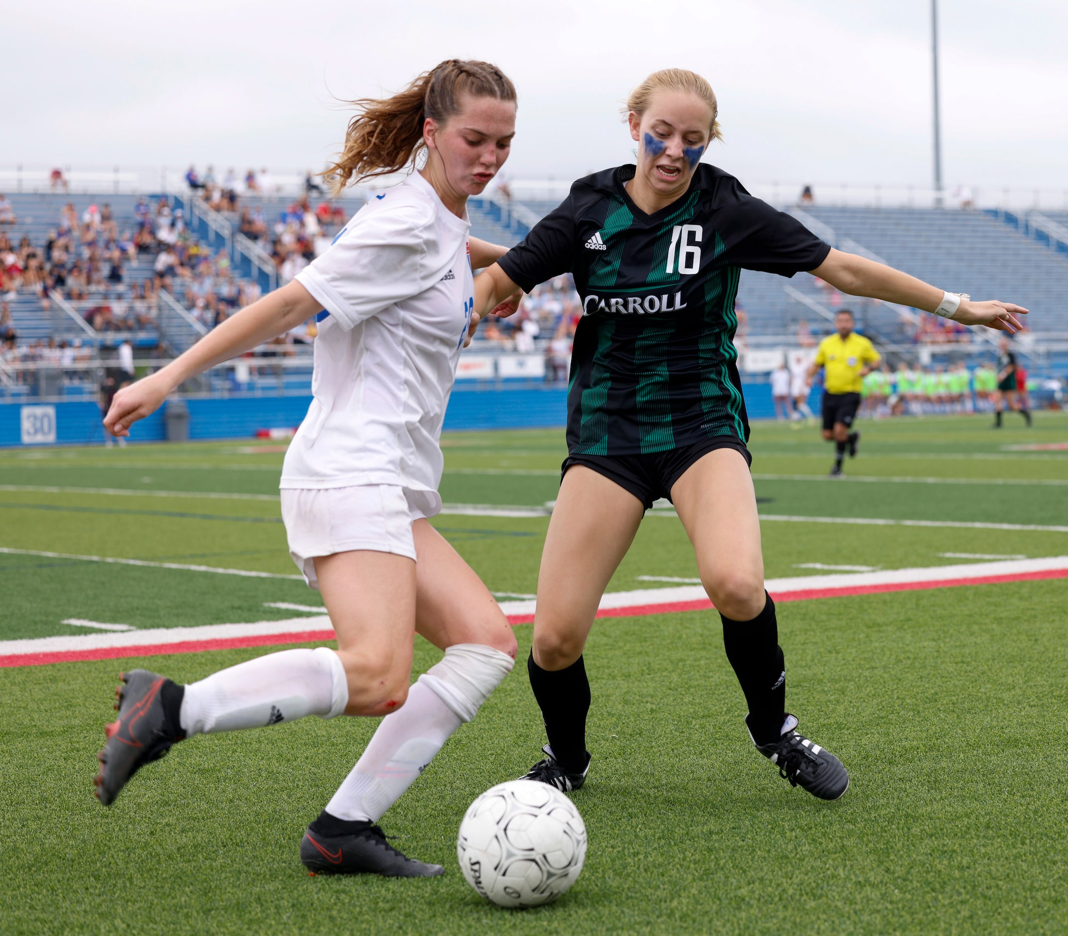 Austin Westlake defender Izzy Scott (20) tries to clear the ball ahead of Southlake...