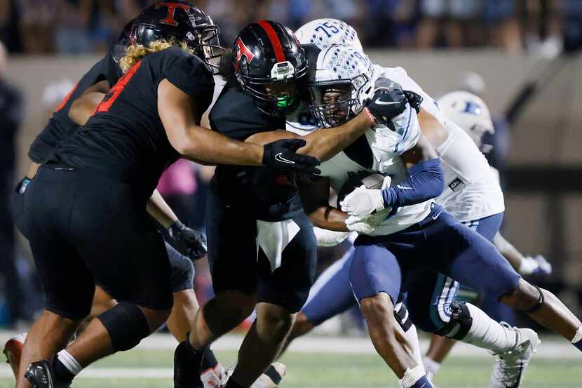 Hurst L.D. Bell running back Gracien Anto (8) is stopped by Euless Trinity linebacker Corey...