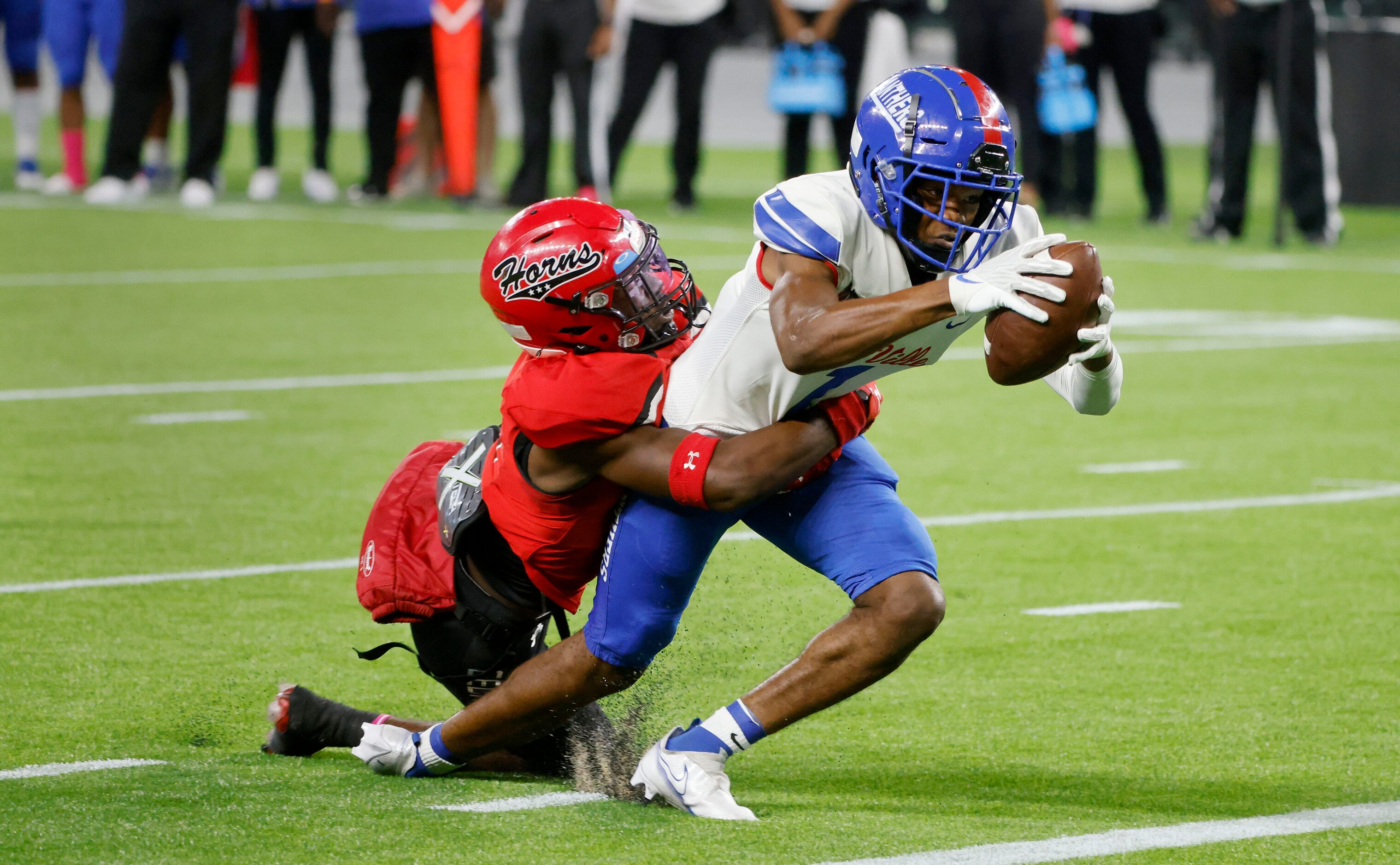 Cedar Hill’s Keandre Jackson, left, tackles Duncanville receiver Lontrell Turner, right, as...