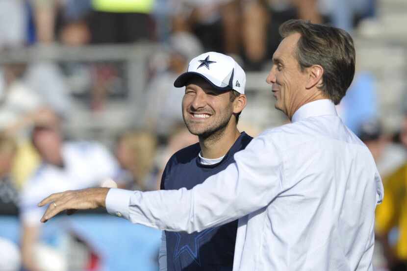 Dallas Cowboys quarterback Tony Romo (left) talks with NBC Sports announcer Cris Cris...