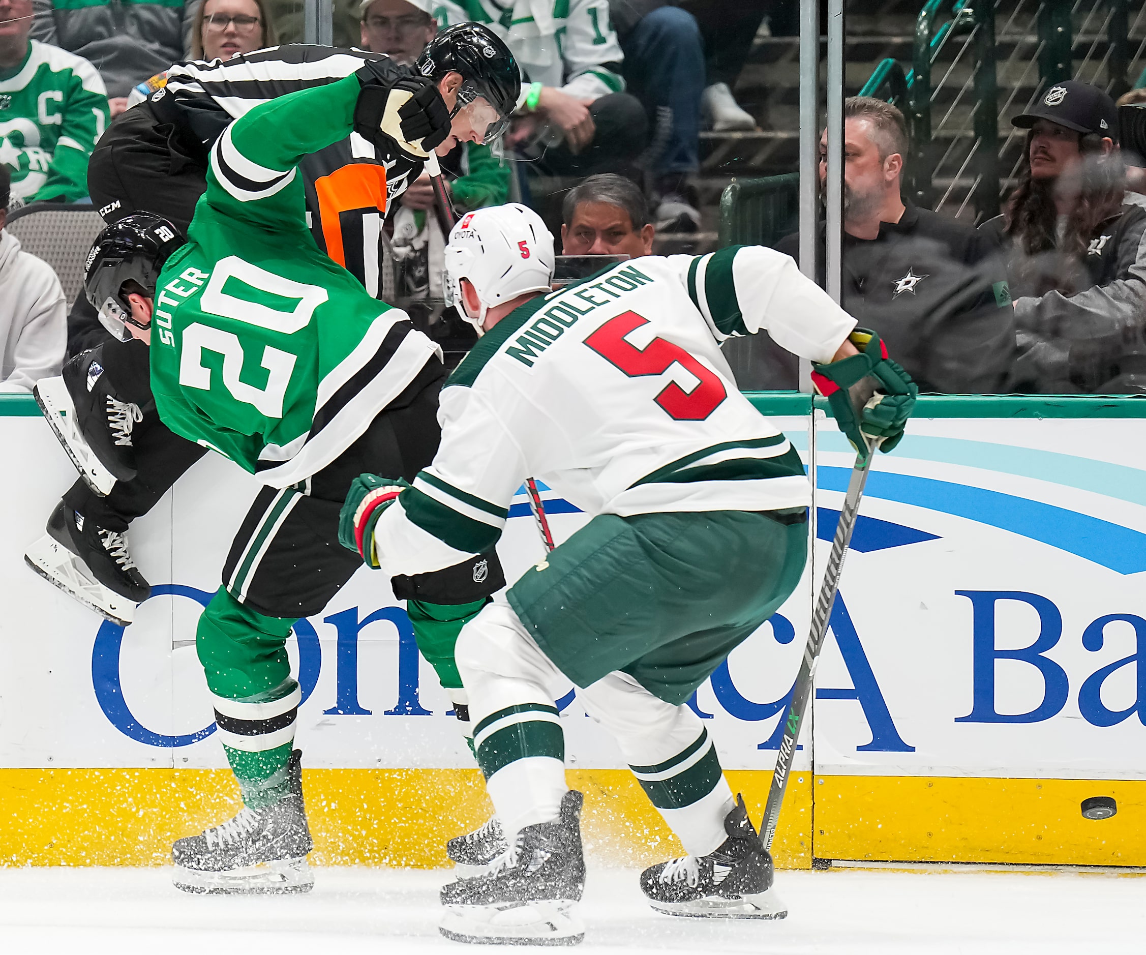 Referee Dan O’Rourke tries to avoid Dallas Stars defenseman Ryan Suter (20) and Minnesota...