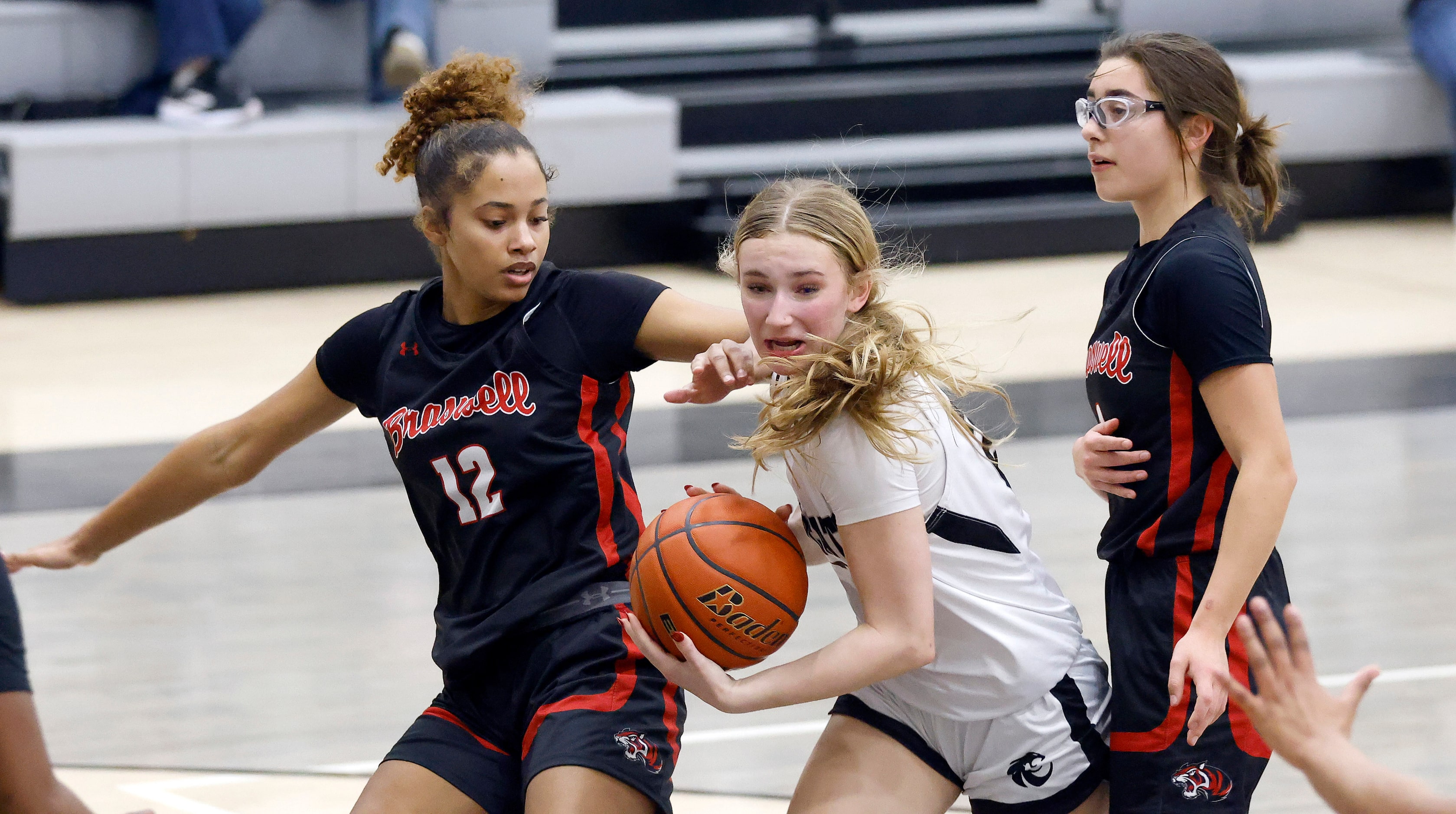 Denton Guyer guard Peyton Underwood (24) drives the lane between Denton Braswell’S Sienna...